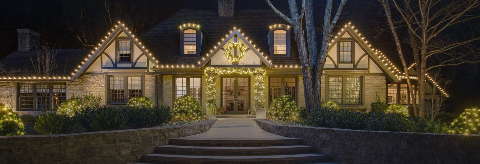 Warm white Christmas roofline lights on a Bakersfield home