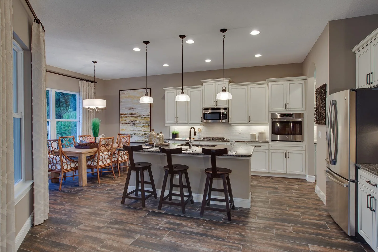 Kitchen and dining area with recessed and pendant lighting