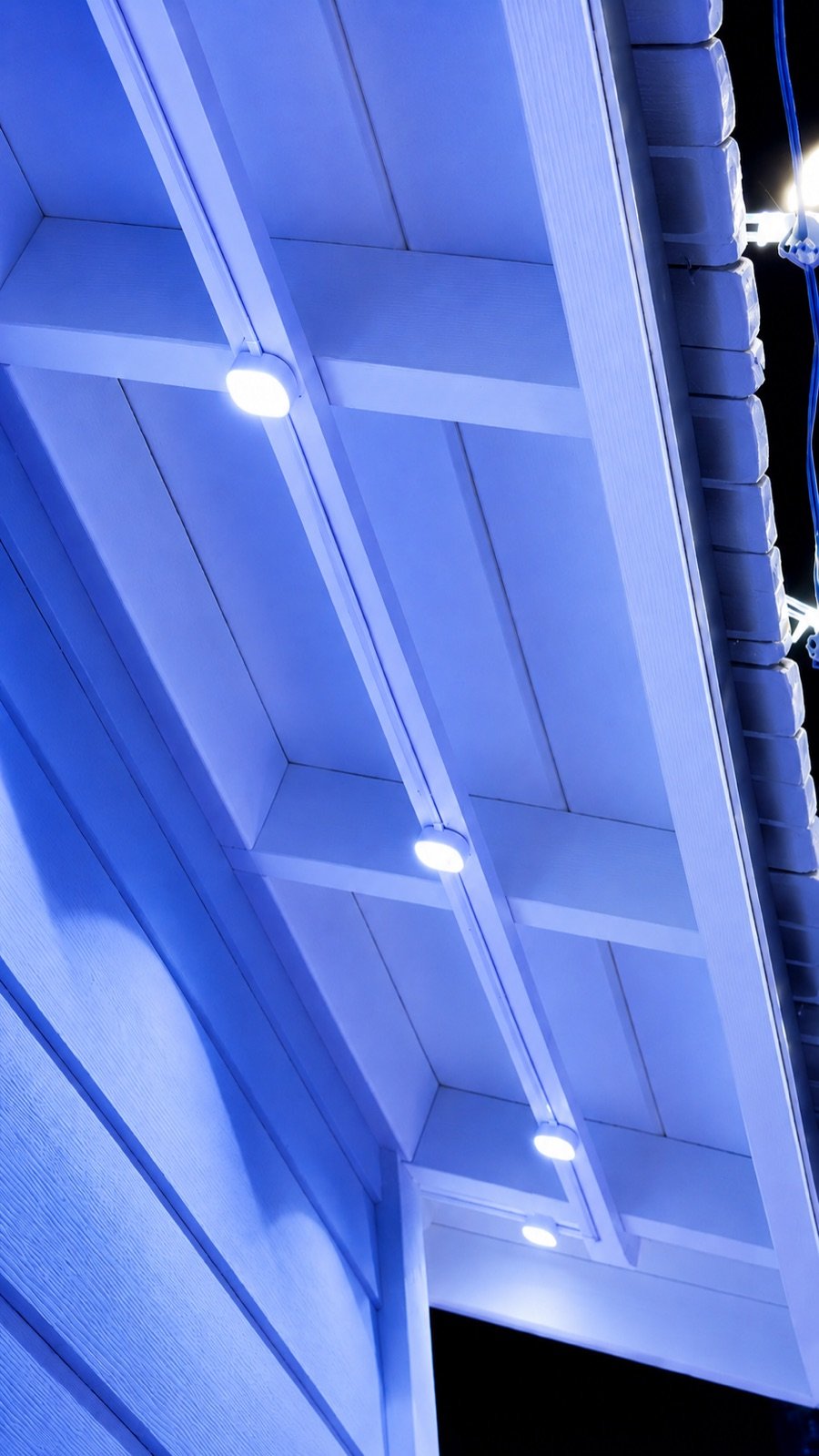 Close soffit detail showing permanent lights mounted on a straight firing strip