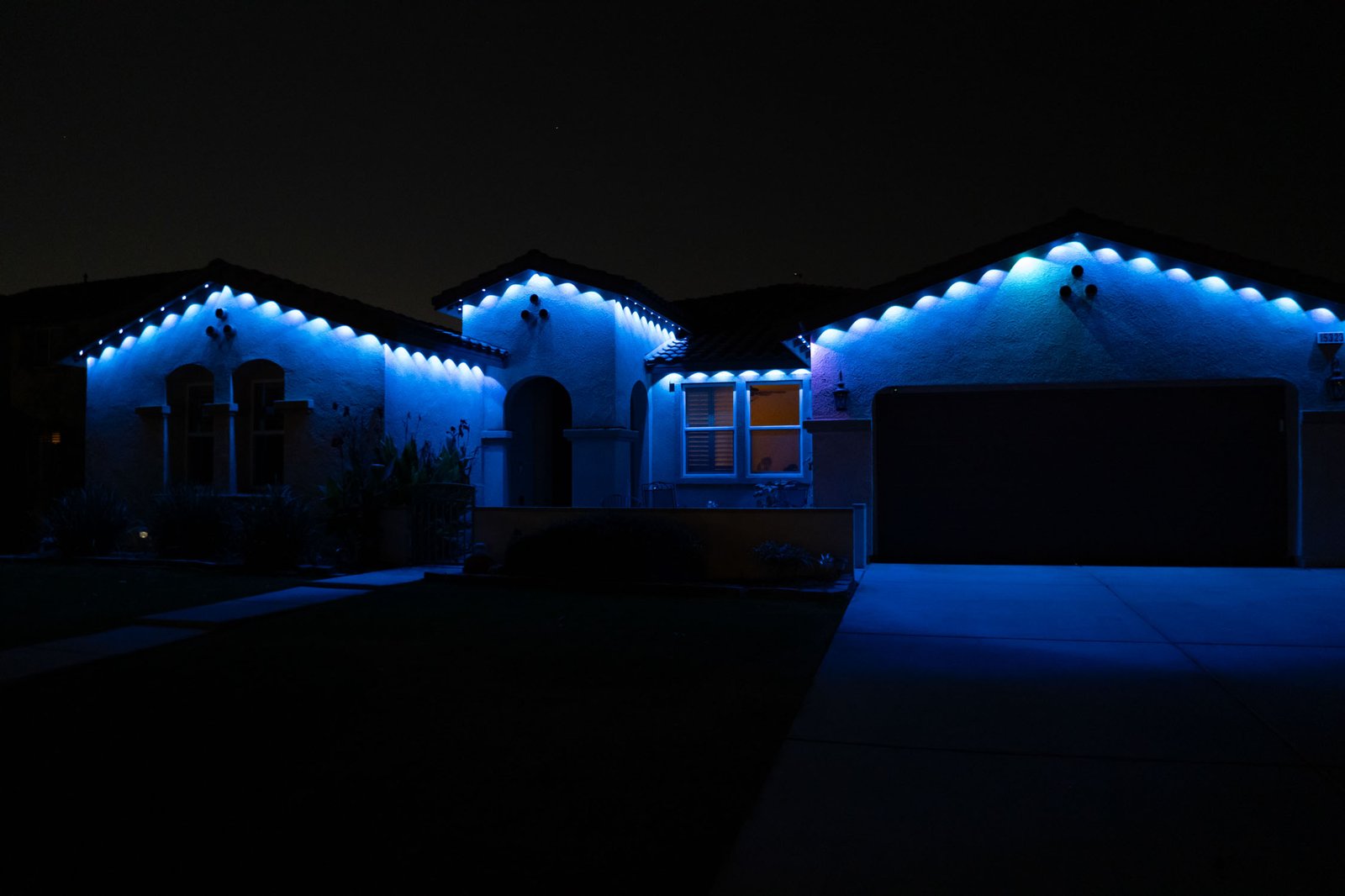 Wide home elevation with permanent blue roofline lighting
