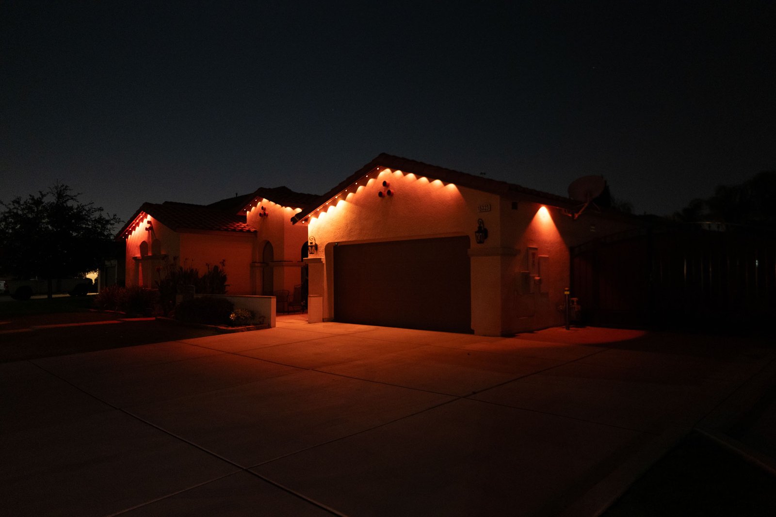 Warm white permanent roofline lighting on a home